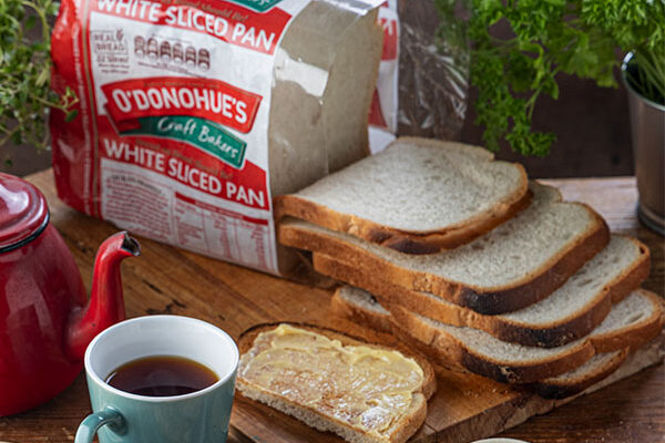 O'Donohue's White Sliced pan on a board with toast and a cup of tea